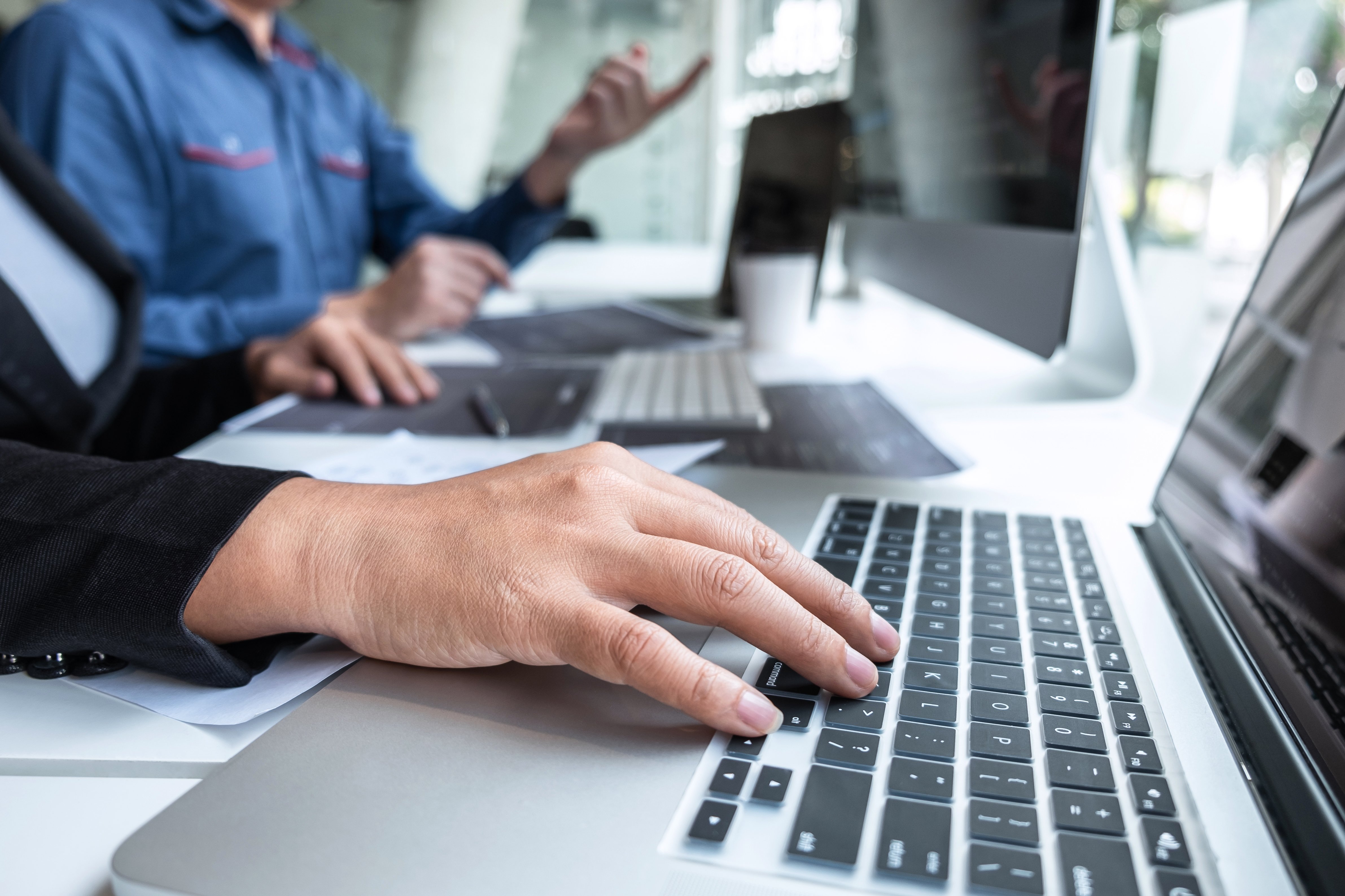 Hands on a laptop keyboard